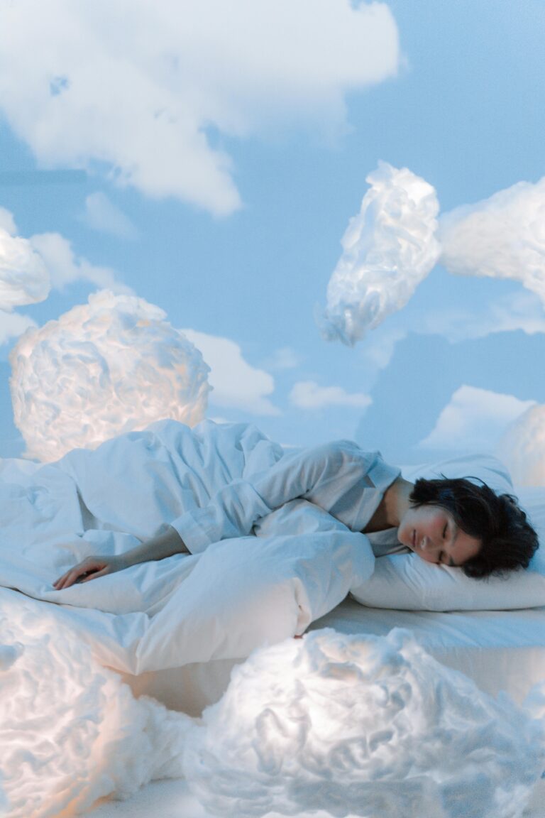 A serene conceptual portrait of a woman sleeping amidst fluffy clouds in a dreamlike atmosphere.